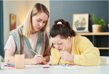 A woman and a young girl collaborate on a project