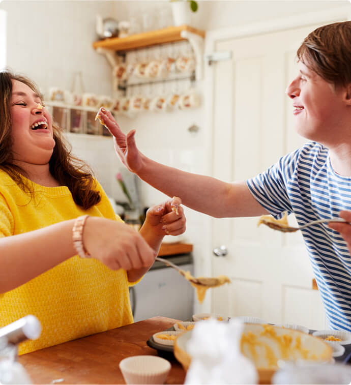 A woman and a man enjoying their time in the kitchen